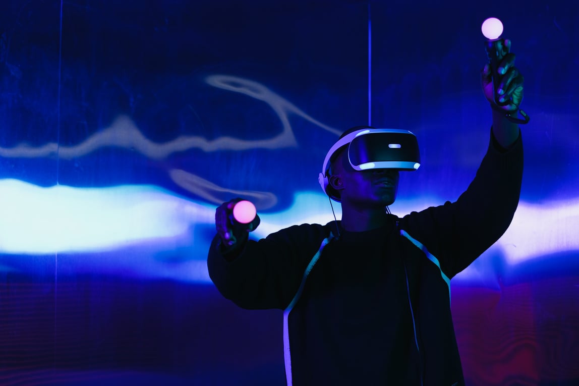 A Man with a Virtual Reality Headset and Controllers